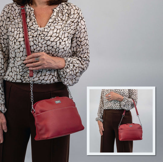 Rebecca - Outlet crossbody bag displayed on model, showcasing red color and stylish chain detailing.